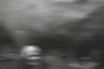 a black and white photo of a man 's face with a blurred background