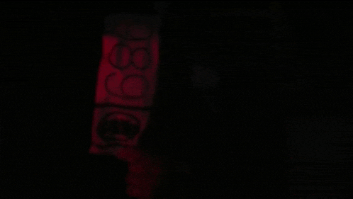 a dark room with a red light coming out of it
