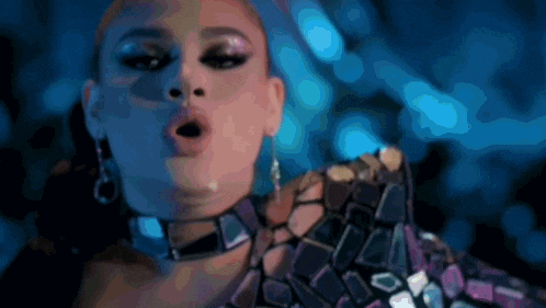 a close up of a woman 's face with her mouth open and a choker around her neck .