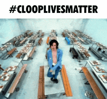 a man in a blue jacket is dancing in a room with tables and benches and the words #clooplivesmatter above him