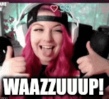 a woman with pink hair is giving a thumbs up while wearing headphones and a hat .