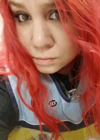 a woman with red hair is wearing a shirt that says ss