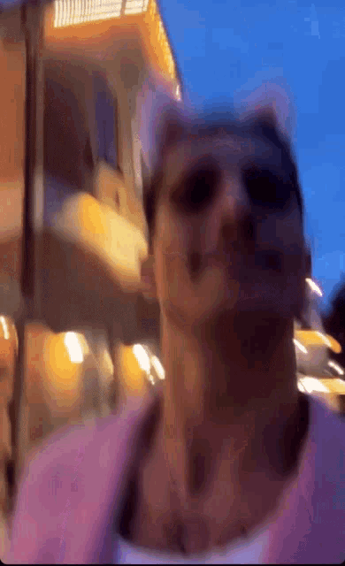 a blurry picture of a person wearing cat ears and sunglasses