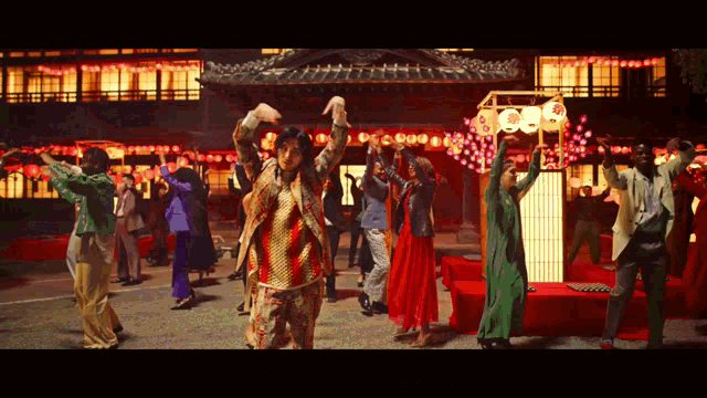 a group of people are dancing in front of a building that has a sign that says ' 00 ' on it