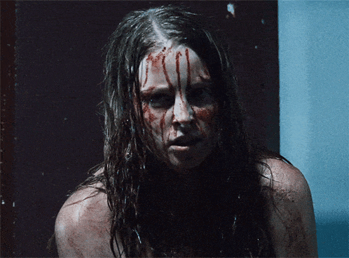 a woman with blood dripping from her face