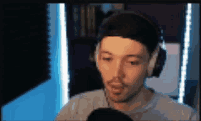 a man wearing headphones is talking into a microphone