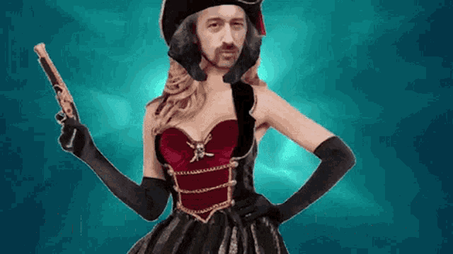a woman dressed as a pirate holds a gun