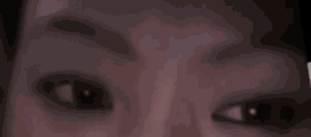 a close up of a person 's eyes with a blurred background