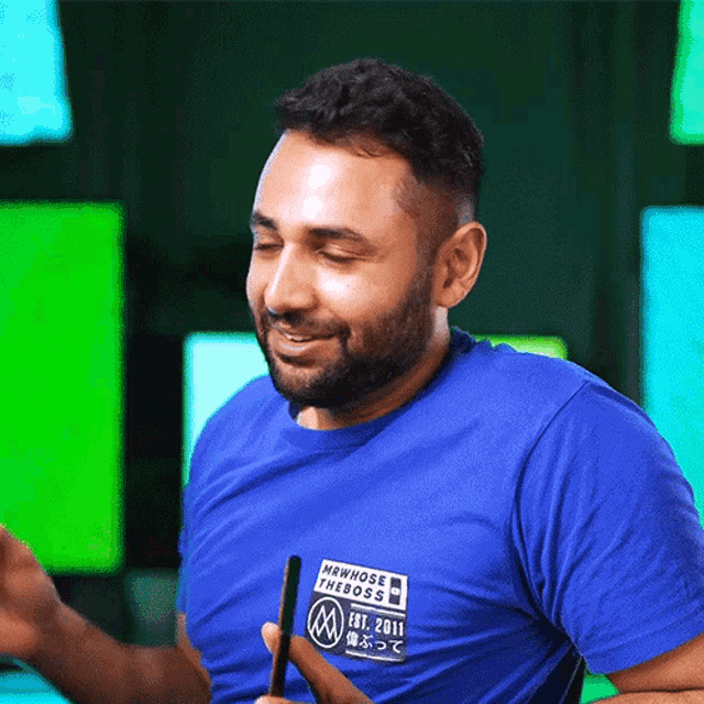 a man wearing a blue shirt that says " nowhose the boss " on it