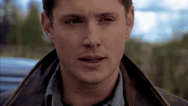 a close up of a man 's face with a serious look on his face .