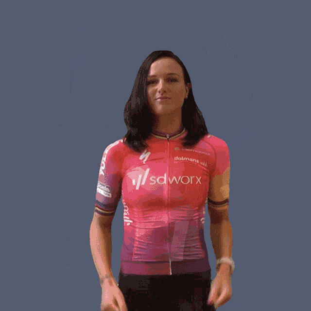 a woman in a sdwork shirt is flexing her arms