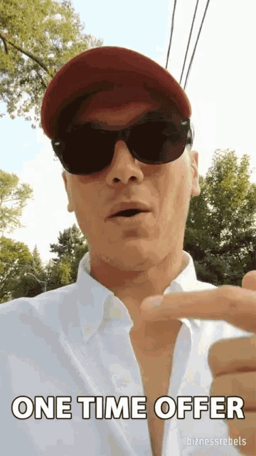 a man wearing sunglasses and a red hat says one time offer on the screen