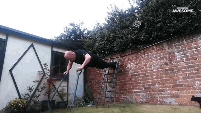 a man is doing push ups on a ladder in front of a brick wall that says awesome on the bottom