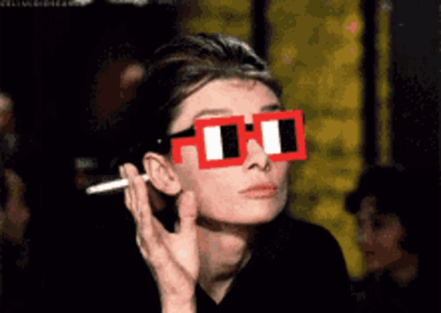 a woman wearing a pair of red and white sunglasses
