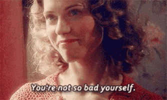 a woman with curly hair is talking to someone and says `` you 're not so bad yourself . ''