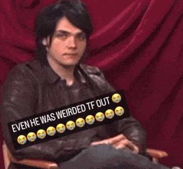 a man in a leather jacket sits in front of a red curtain with a caption that says even he was weird