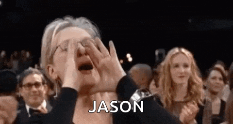 a woman is crying in front of a crowd at an awards show while holding her hands to her face .