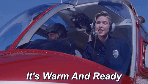 a woman in a pilot 's seat with the words it 's warm and ready below her