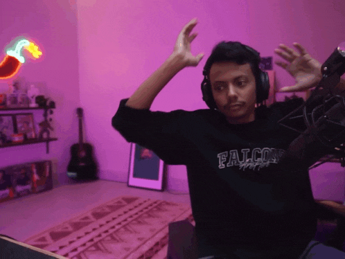 a man wearing headphones and a shirt that says falcons on it