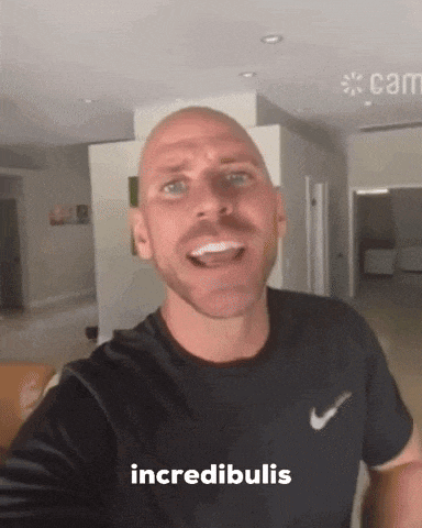 a bald man with a beard is wearing a nike shirt