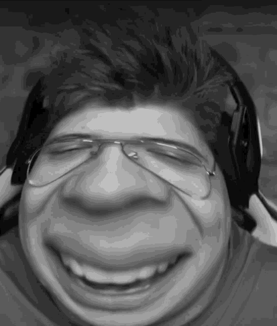 a black and white photo of a man wearing headphones and glasses