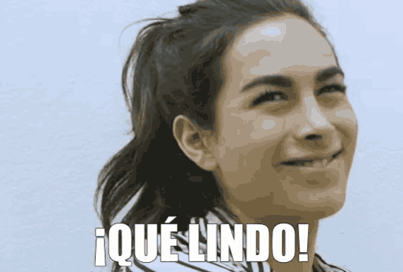 a woman with a ponytail is smiling and the words que lindo are below her