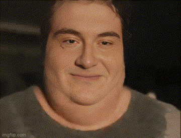 a close up of a man 's face with a very large neck and a smile on his face .