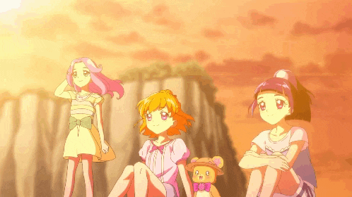 three anime girls and a teddy bear are sitting in front of a cliff
