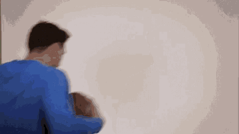 a man is wearing a blue shirt with the number 5 on it .