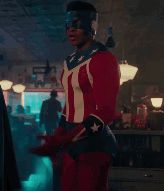 a man in a superhero costume stands in a diner