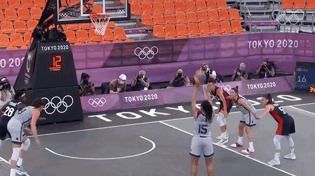 a basketball game is being played at the tokyo 2020 olympic games