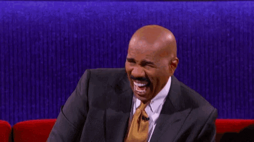 a bald man in a suit and tie is smiling