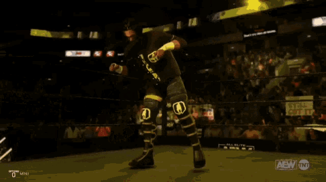 a man in a wrestling ring with the letters aew on the bottom