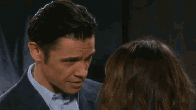 a man and a woman are looking into each others eyes