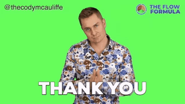 a man in a floral shirt is giving a thank you gesture on a green screen .