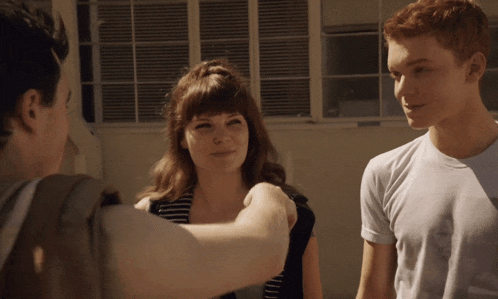 a man and a woman are standing next to each other and talking