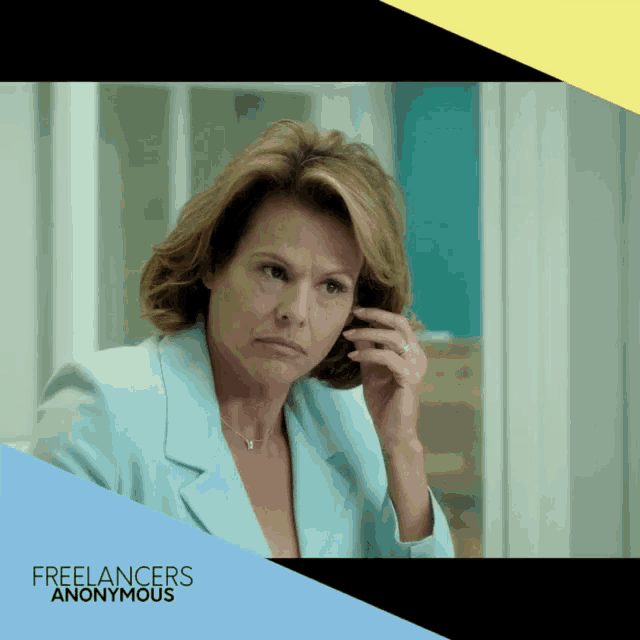 a woman in a blue jacket talking on a cell phone