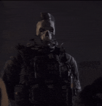 a man wearing a skull mask with sas on his chest