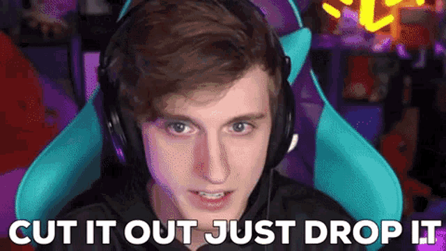 a young man wearing headphones is sitting in a chair and says cut it out just drop it .
