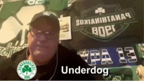 a man wearing headphones stands in front of a sign that says pa 13