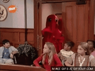 a group of children are sitting in a room with a nickelodeon logo on the wall
