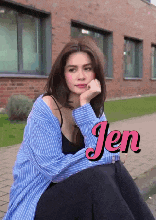 a woman in a blue and white striped shirt is sitting in front of a brick building with the name jen on the bottom right