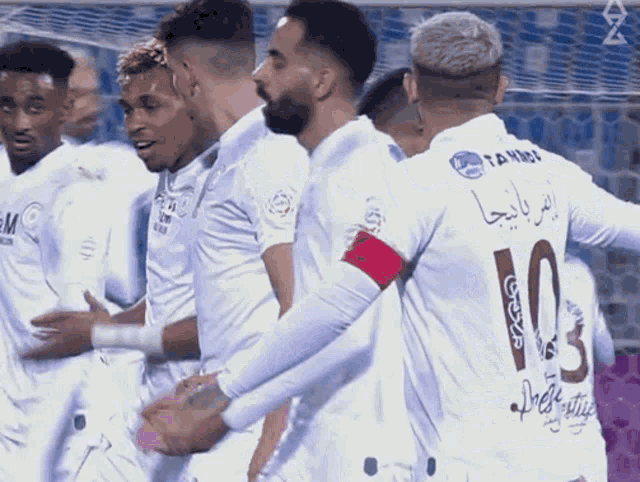a group of soccer players one of whom is wearing a number 10 jersey