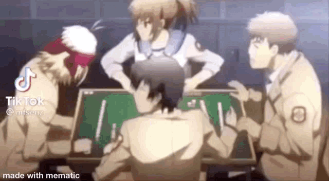 a group of people are sitting around a table playing a game of cards .