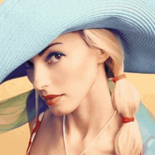 a woman wearing a blue hat with a red lip