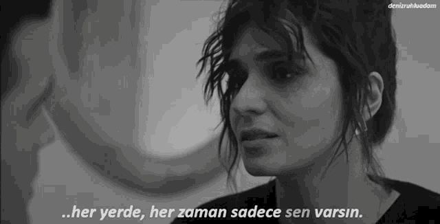 a black and white photo of a woman and a man with the words her yerde her zaman sadece sen varsin