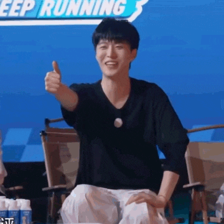 a man is sitting in a chair giving a thumbs up .