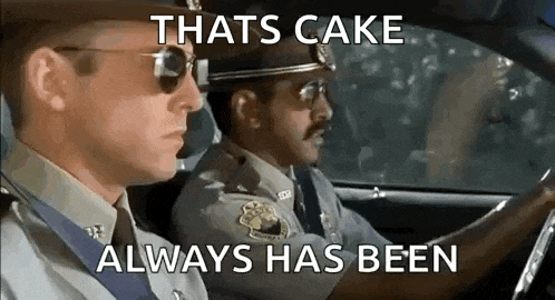 two police officers are driving a car with the words `` thats cake always has been '' .