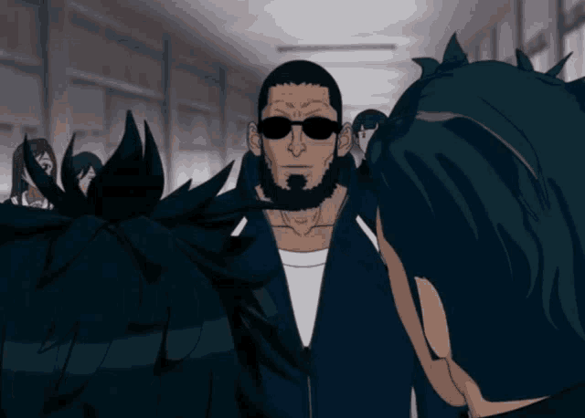 a man with a beard and sunglasses is standing in a hallway