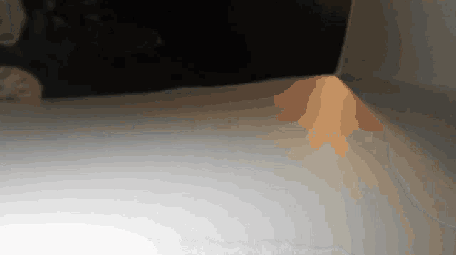 a corner of a dark room with a light shining through it